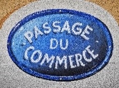 A blue enamelled plaque bearing the inscription ‘Passage du commerce’